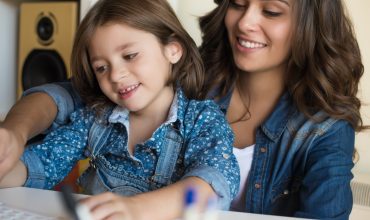Woman and little girl using computer Woman and little girl using computer