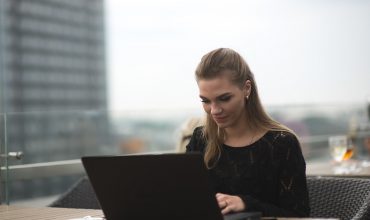 Young adult woman using laptop and smartphone Young adult woman using laptop and smartphone