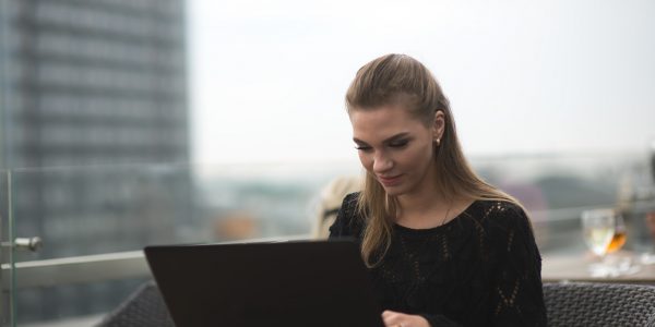 Young adult woman using laptop and smartphone Young adult woman using laptop and smartphone